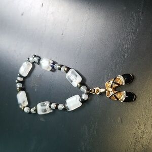 Handmade bracelet with black and white beads and ballerina slippers. 🩰